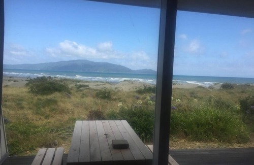 Waikanae House | Iconic absolute beachfront 60s bach
