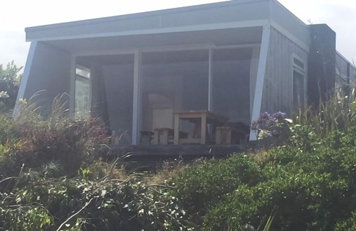 Waikanae House | Iconic absolute beachfront 60s bach
