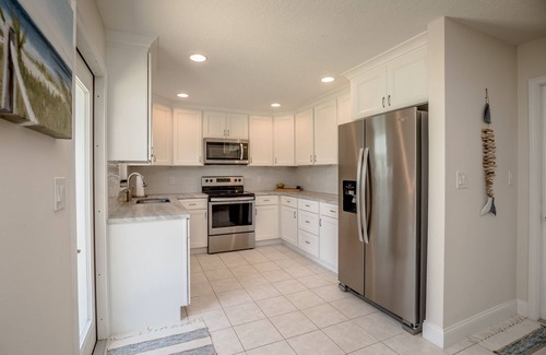 Micco House | Indian River Waterfront Home with private dock, heated pool, fenced back yard