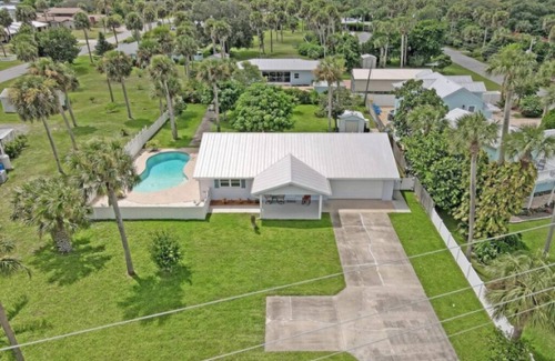 Micco House | Indian River Waterfront Home with private dock, heated pool, fenced back yard