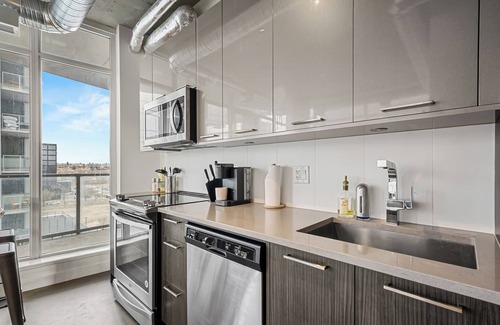 East Village Apartment | Industrial 1BR w Office, Views, AC, XL Patio