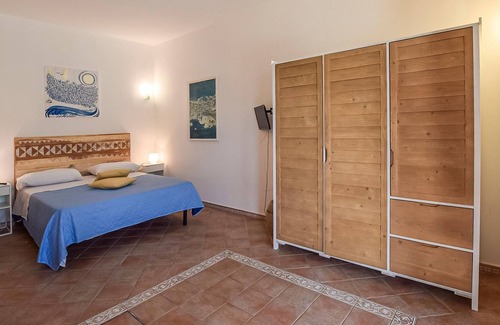 Sant'Angelo House | Inviting cottage with charming outdoor area and limited sea view.