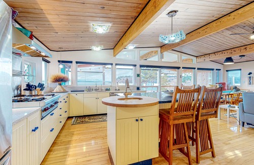 Clinton House | Inviting Puget Sound view home with beach access, fire table, hot tub, & W/D