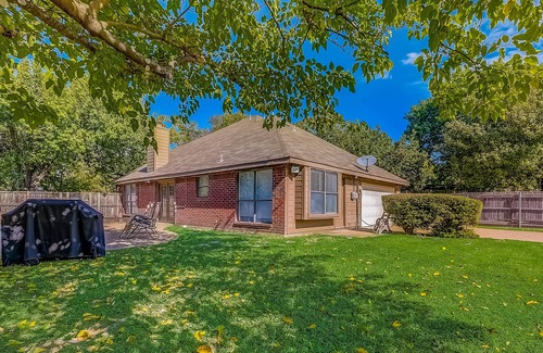 Dallas House | Inviting, two-story home on a large lot with a private pool, gas fireplace, & AC