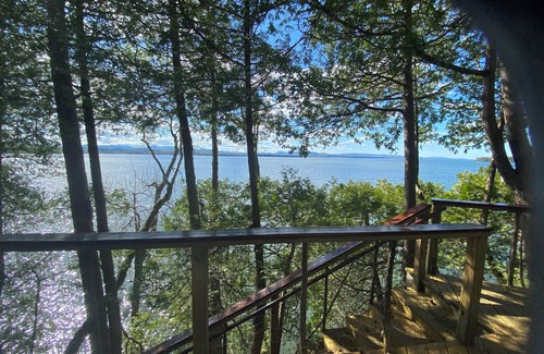 Charlotte Cabin | Lake Champlain camp, spacious deck, sunset & mountain views, beach and dock