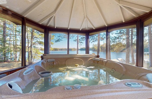 Lac du Flambeau House | Lakefront house with private covered hot tub, dock, wood fireplace, & firepit