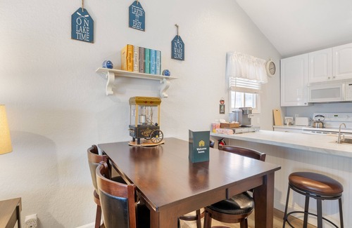 Lake Ozark Condo | Lakefront top-floor condo with grill, screened-in balcony, pool, fireplace, W/D