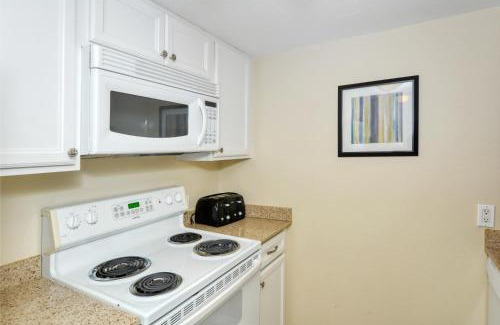 Longboat Key Apartment | LaPlaya 101E-Relax on your private lanai under the palms!
