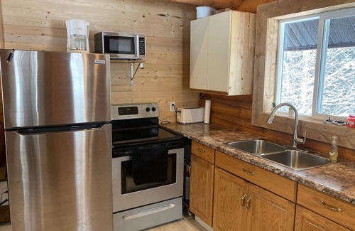 Central Okanagan Apartment | Log lofted rustic cabin in woods
