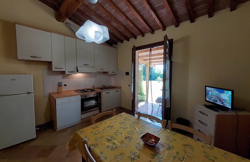 Rosignano Marittimo Apartment | Lovely flat with private covered terrace, pool, large shared garden.