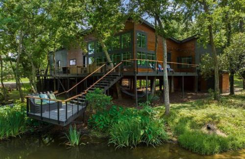 Montgomery House | LUX Treehouse on Private Lake next to Lake Conroe with Game room, Paddleboards, Lake Views, and more!