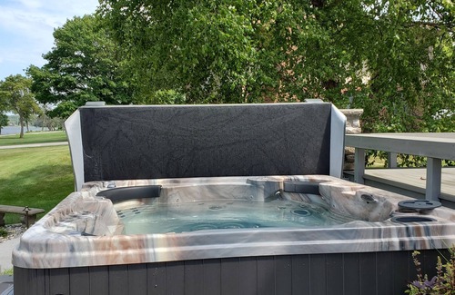Rapids City House | Luxury river front two-bedroom carriage house with private deck and hot tub.