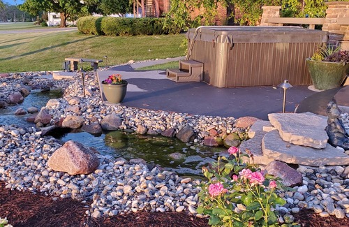 Rapids City House | Luxury river front two-bedroom carriage house with private deck and hot tub.