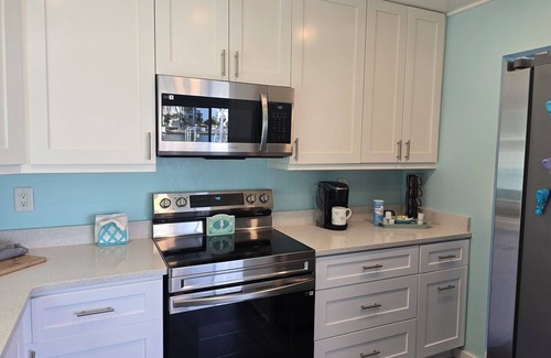 Treasure Island Villa | Million Dollar Views! Waterfront 2 bedroom/2 bath duplex with pool and dock.