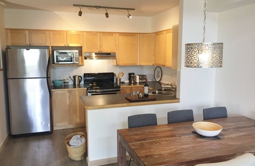 Canmore Condo | Modern, rustic mountain view loft style condo with pool, hot tubs & XL beds.