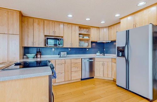 Adelma Beach House | Modern water view retreat with foosball table, expansive deck, and gas fireplace