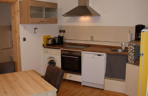 Friedrichroda House | Modernly furnished bungalow with fireplace, surrounded by greenery.