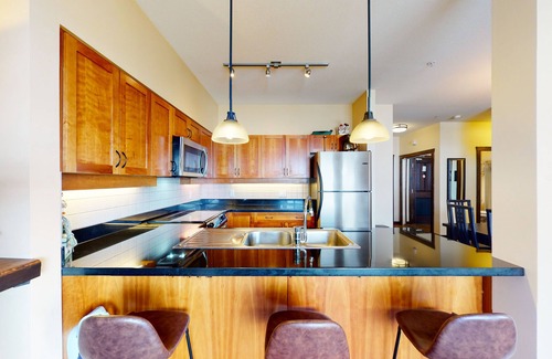 Big White Ski Resort Condo | Mountain view ski-in/out home with a hot tub & fireplace - walk to village