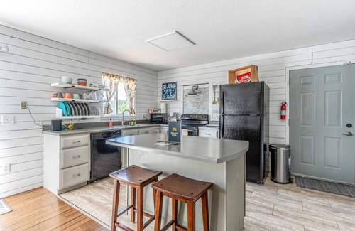 Woods Bay House | Mountain-view home with large deck, gas grill, firepit, lawn, and central AC