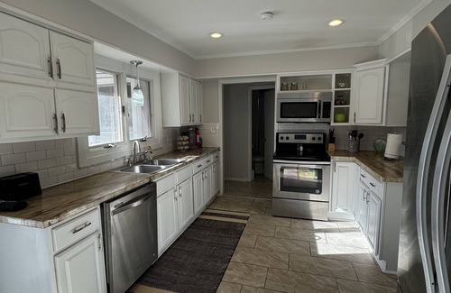 Wichita House | Near WSU: Bumper Pool and Fire Pit! Hosted by Homes by CNJ