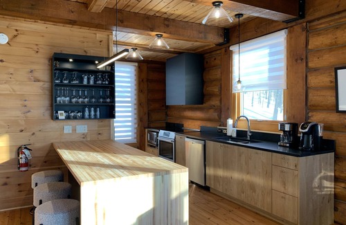 Lac Superieur Village Ski Chalet | Newly renovated log home with private spa and lake access.