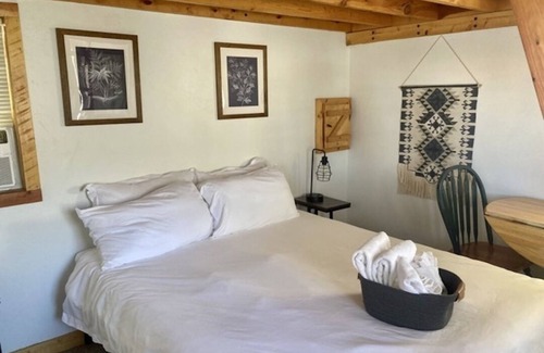 Montrose Cabin | One room camping cabin Double bed on the main level and two lofted twin-size beds Heating and cooling Sleeps: 4 Pets: 2 Parking: 1