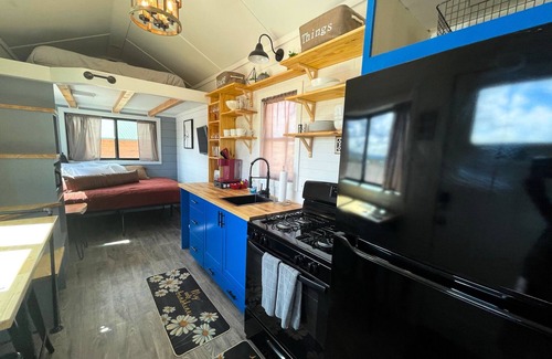 Meeker House | Our newest and one of our largest tiny homes contains a queen bed on the main level and two queen lofted beds. Sleeps: 6