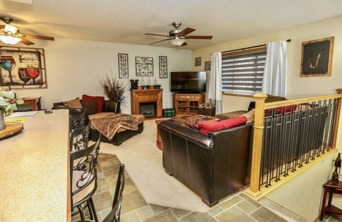 Aberdeen House | OurCozyOasis, Relax in the warmth of the fireplace in this homey upstairs.