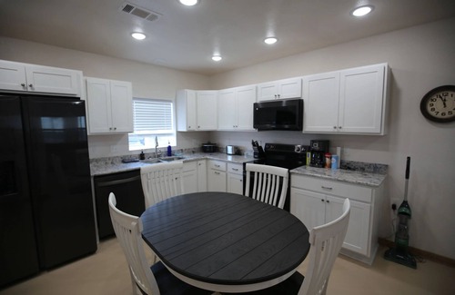 Sabine Pass Cottage | Park your boat in front of the Fishermen's Cottage! Screened in patio.