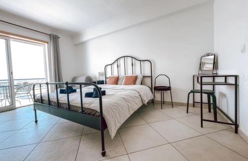 Sao Bernardino House | Peniche master bedroom with sea view balcony, private bathroom, shared kitchen, swimming pool, surfing resort