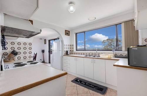 Lakes Entrance House | Perched on a slope, this retreat offers views of the ocean in the distance