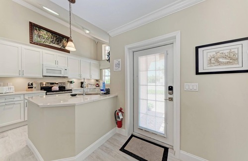 Holmes Beach Condo | Pink Flamingo in Palm Isle Village - 2BR Condo with Pool - By Island Real Estate