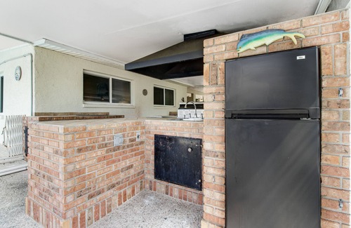 Bayshore Gardens House | Riverfront home with screened private pool, outdoor kitchen, & water access