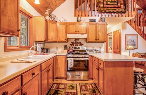 Lac du Flambeau Cabin | Riverfront vacation home with a dock, wood stove, full kitchen, & firepit