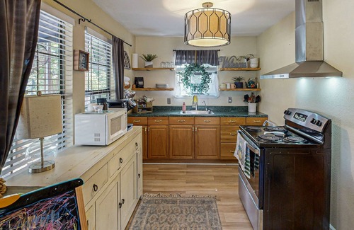 Bandera Cottage | Riverside Retreat with outside dining area, deck and internet