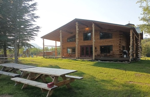 Buckinghorse River Cabin | Room 2 at the Main Lodge with a queen bed and single bed.