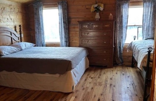 Buckinghorse River Cabin | Room 4 at the Main Lodge with a queen bed and single bed.