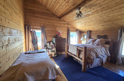 Buckinghorse River Cabin | Room 5 at the Main Lodge with a queen bed and single bed.