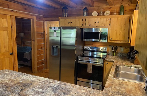 Logan Cabin | Rustic Getaway Cabin equipped with Hot Tub, trails on property, private!