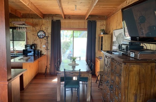 Goughs Bay Cabin | Rustic log cabin perched high on Goughs Bay