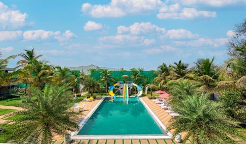 Bhiwandi Villa | SaffronStays Palm Paradise, Kalyan Khadavli - swimming pool with water slides, gazebo and indoor games