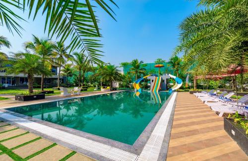 Bhiwandi Villa | SaffronStays Palm Paradise, Kalyan Khadavli - swimming pool with water slides, gazebo and indoor games