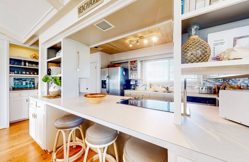 Royal Lagoons House | Serene sound-front home with a covered patio, dock, and swing bed