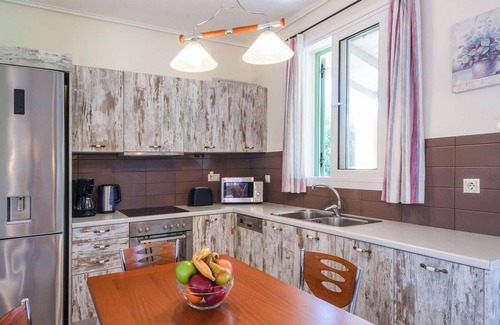 Almiros Beach House | Situated within a short walk of the beautiful sandy beach at Almiros, this quaint villa sits within
