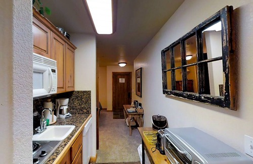 Four O'Clock Apartment | Ski-in/out studio condo with heated underground parking, hot tub & grill