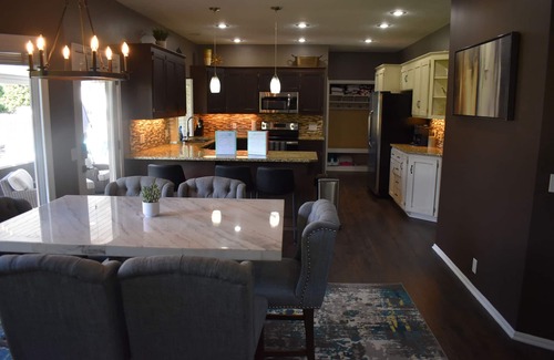 Omaha House | Spacious 5-bed 4-bath retreat. Backyard oasis with pool, hot tub, and fireplace.
