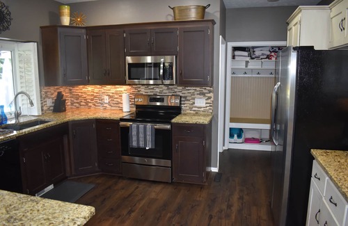 Omaha House | Spacious 5-bed 4-bath retreat. Backyard oasis with pool, hot tub, and fireplace.