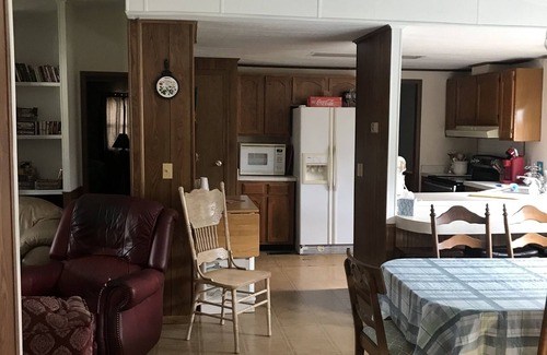Tow House | Spacious open floor plan with beautiful oak trees.