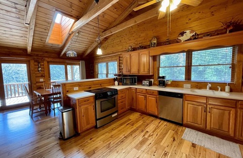 Lansing Cabin | Spacious Riverfront Log Cabin w/Hot Tub, Pet Friendly, Pool Table, Firepit