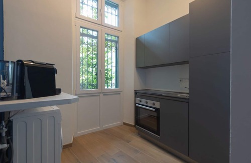 San Donato - Campidoglio Apartment | Studio apartment with double bed, armchair bed and equipped kitchenette.